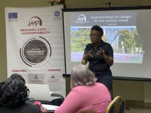J Calder presenting at workshop in front of screen